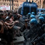 Italy protests: Dozens hurt in Bologna after man dies while being restrained by police
