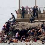 Hundreds of migrants swim from Morocco to Spanish enclave of Ceuta