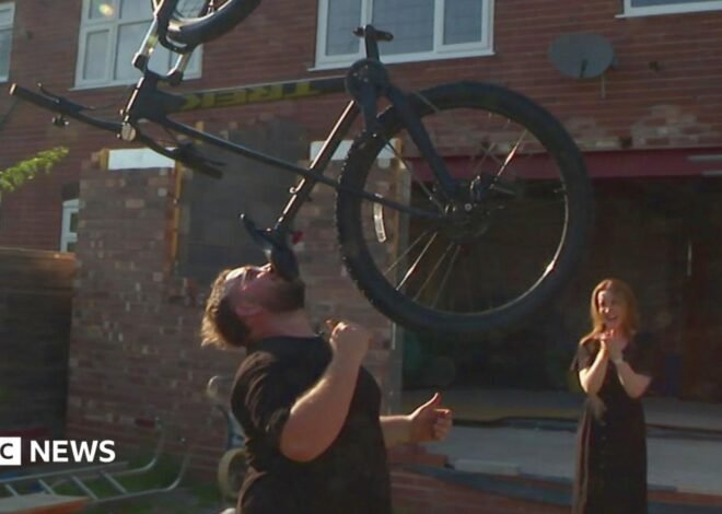 The man who balances bikes, ladders and sheds on his chin