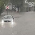 Watch: Flash flooding interrupts half-marathon, submerges cars