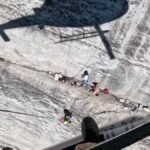 Watch: Helicopter hovers feet from cliff face during rescue