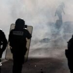 Teenager’s hand blown off during confrontation between France school protesters and riot police